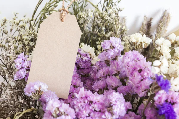 Bouquet of dried flowers with blank paper tag