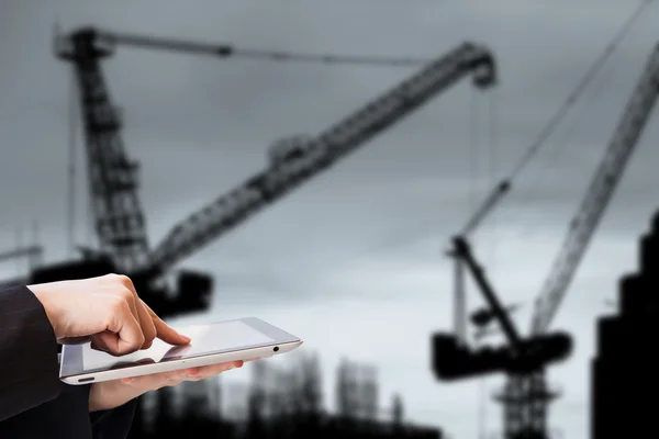 Businesswoman using tablet in construction site
