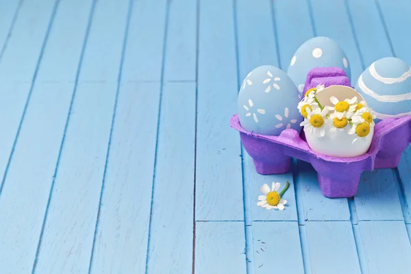 Painted eggs and daisy flowers