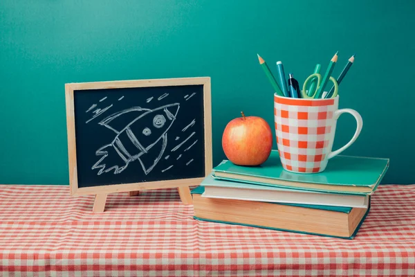 Chalkboard, books and apple