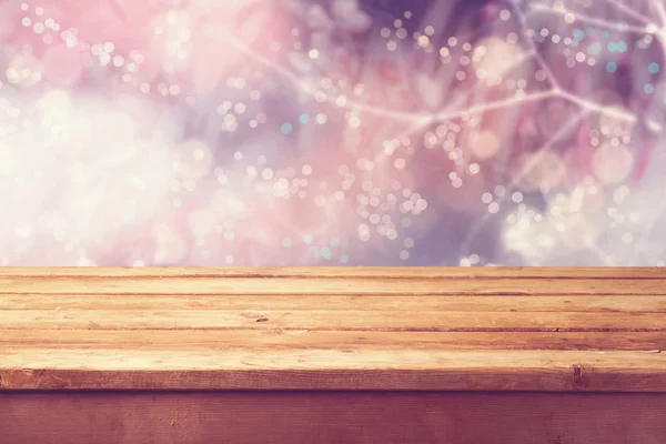 Winter bokeh background and wooden table