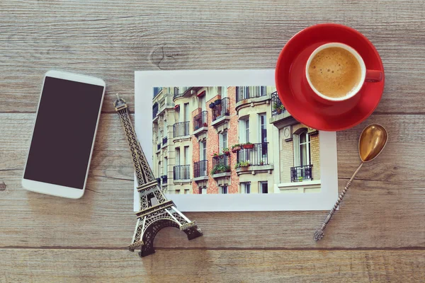 Photo of buildings with cup and smart phone