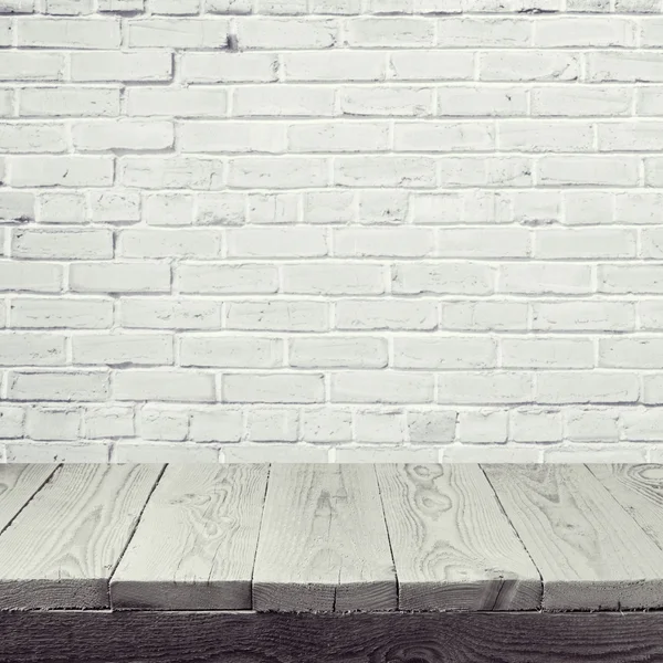 Wooden table over white brick wall