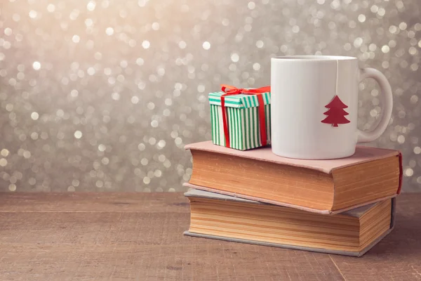 Cup and gift box on books