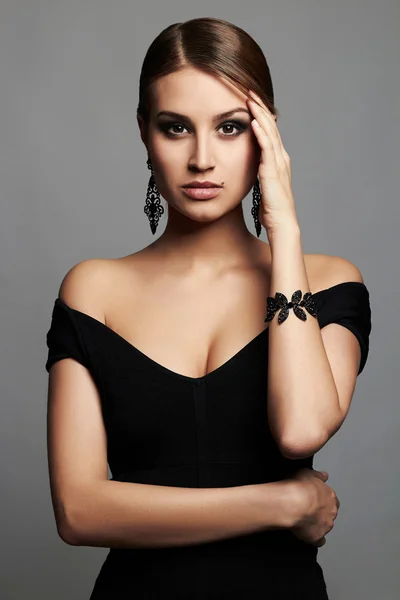 Beautiful sexy woman.Beauty girl with short hair and make-up.elegant lady in black dress and jewelry