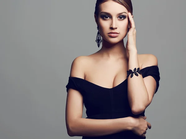 Young beautiful sexy woman.Beauty girl.elegant lady in black dress and jewelry