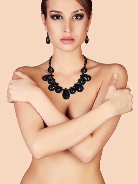 Naked girl in jewelry. beautiful sexy woman with short hair and make-up