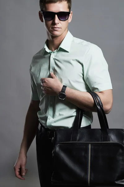 Young man with a handbag.