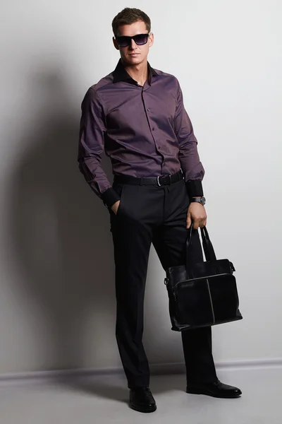 Handsome man with handbag