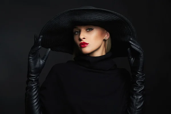 Woman in hat and leather gloves