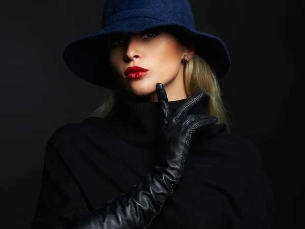 Beautiful woman in hat and leather gloves