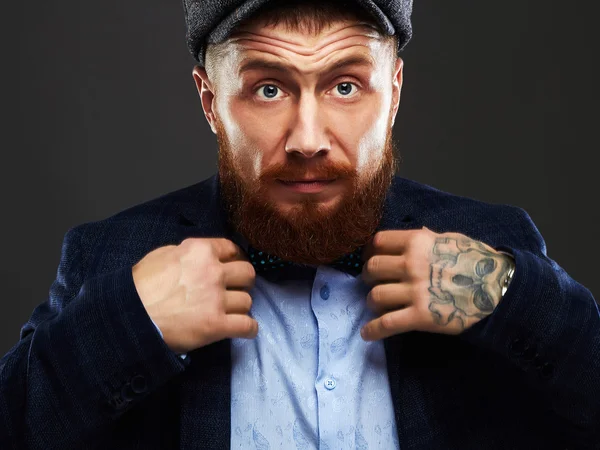 Man with beard and tattoo.old Hipster boy.brutal handsome man in hat