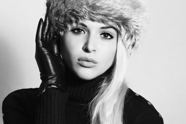 Young Woman in Fur Hat. Beautiful Blond Girl in Black Leather Gloves. Winter Fashion Beauty