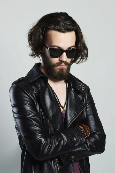 Fashionable young bearded man in a leather jacket. Hipster