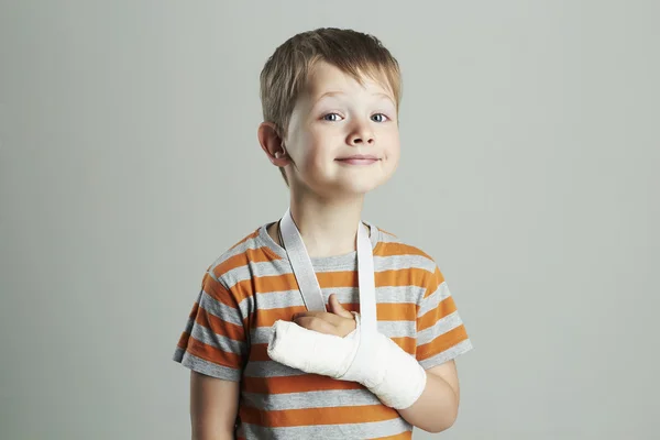 Little boy in a cast.child with a broken arm. funny kid after accident