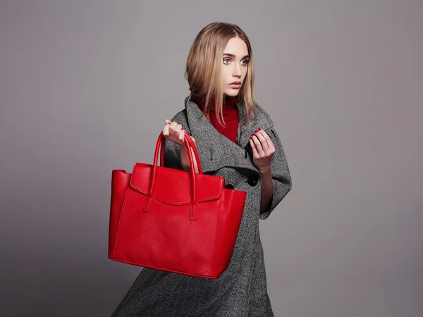Beautiful Woman with Handbag.Beauty Fashion Girl in topcoat.winter Shopping