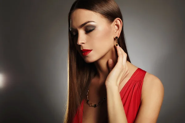 Young beautiful sexy woman.Beauty girl wearing jewelry.elegant lady in red dress