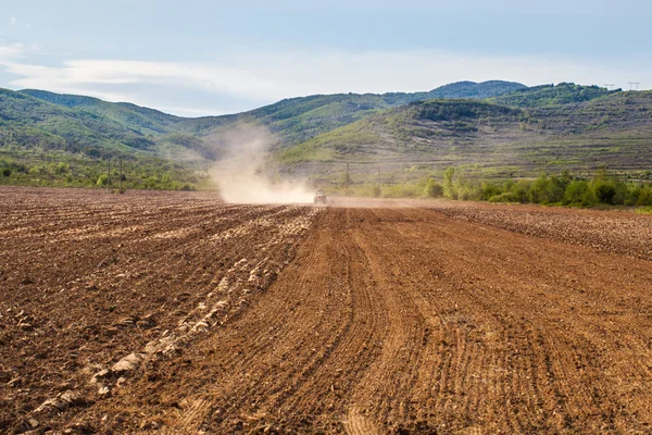 Plowing Tractor on Agricultural Field