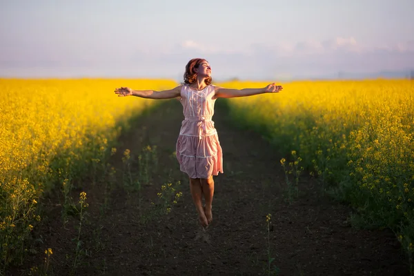 Happy woman  in the yellow meadow