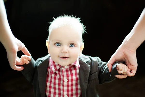 Cute baby boy against brawn background