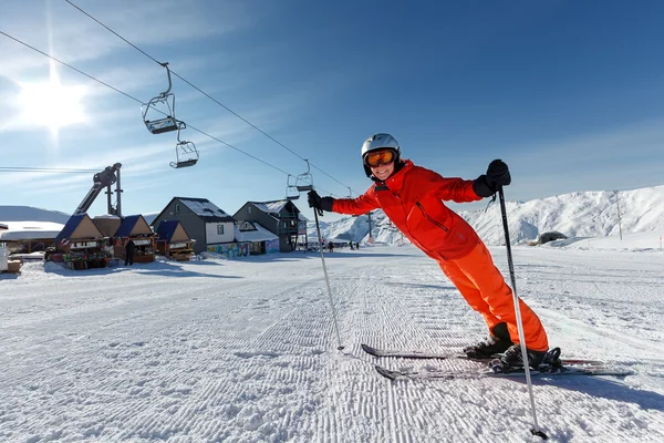 Skier warms up before descent from high winter mountain in Gudau