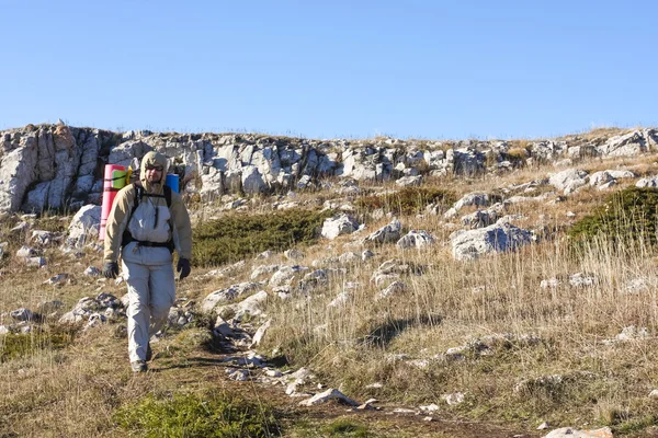 Hiker is descending mountain in Crimea mountains