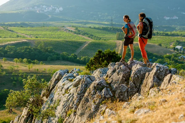 Two women is trekking in the Crimea mountains with backpacks