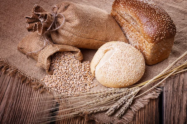 Fresh bread, wheat ears and grain