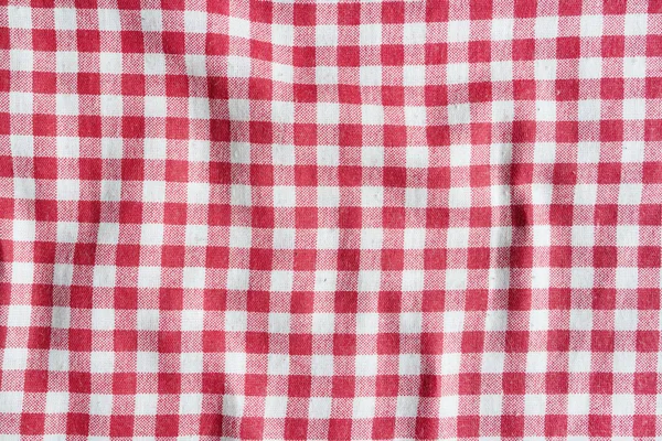 Texture of a red and white checkered tablecloth.
