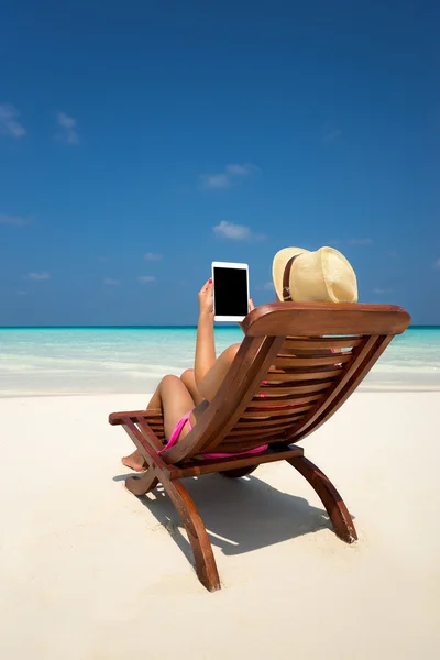 Blank empty tablet computer in the hands of women on the beach