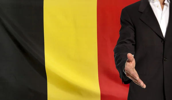 Open hand and Belgium flag in the background