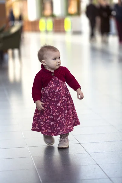 Toddler girl walking through mall  first steps