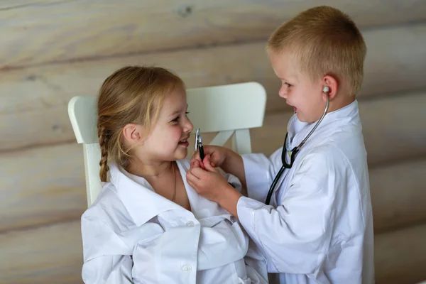 Girl and boy playing doctor