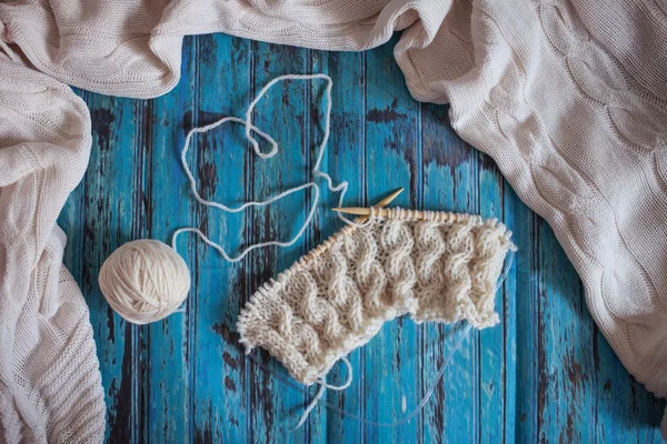 Knitting with white woolen thread, knitting with braids