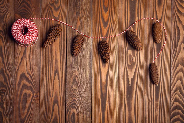 Garland of cones, Christmas mood on the wooden background