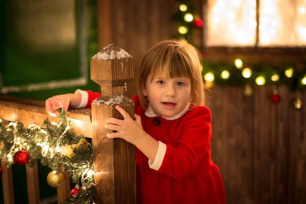 Toddler girl in santa dress with lights, Christmas and New Year