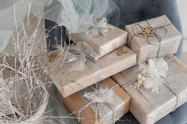 Wrapped gift boxes with silver Christmas ornaments