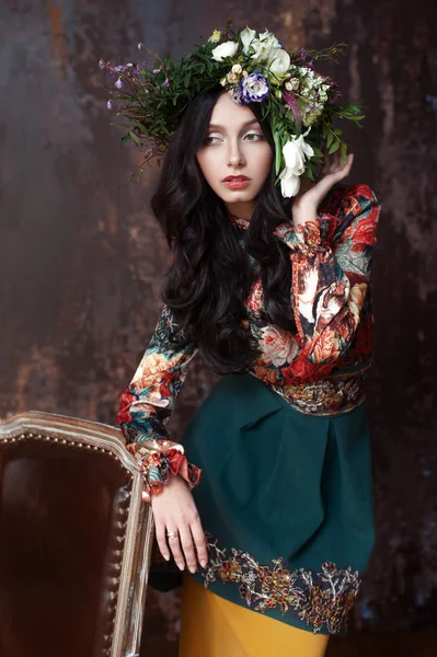 Beautiful Woman with Curly Hair, Makeup and Flowers Wreath