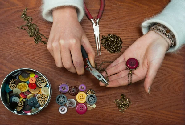 Woman making craft jewellery