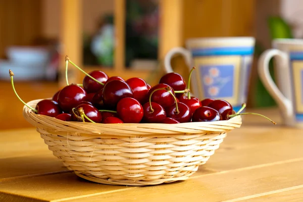 Wicker basket with fresh sweet cherries
