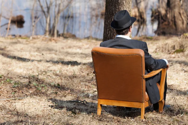 Man sitting alone in a armchair
