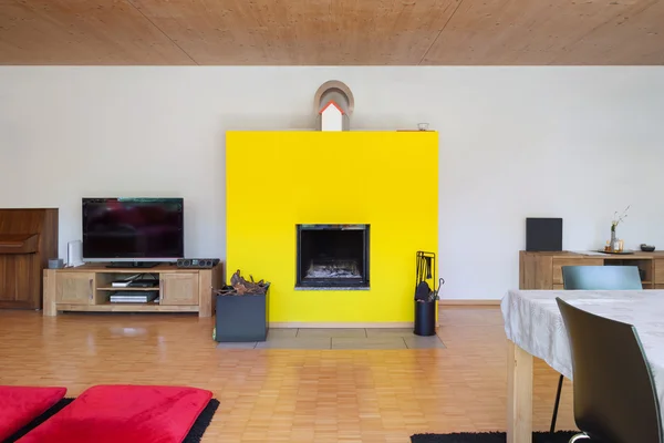 Interior, living room with yellow fireplace