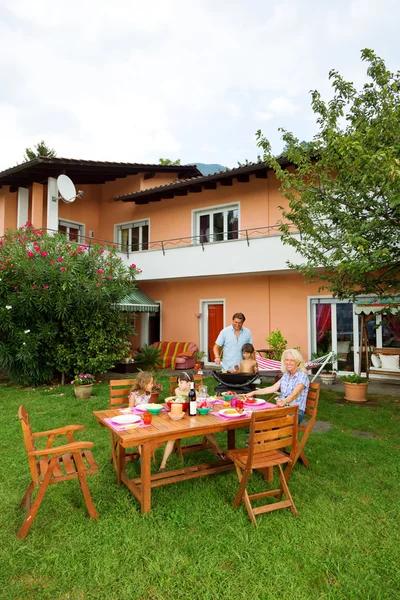 Family having a barbecue in the garden, eating