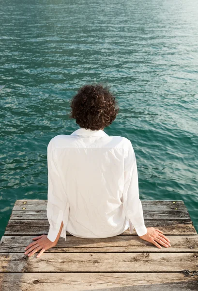 Young man on the dock of Lake