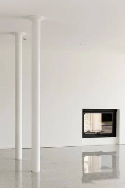 Empty room with pillar and fireplace
