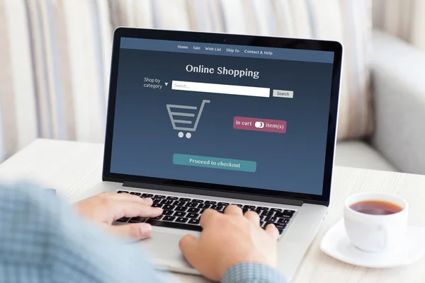 Man sitting at a computer and makes online shopping