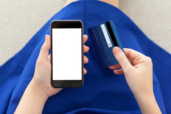 Woman holding a phone with isolated screen and credit card