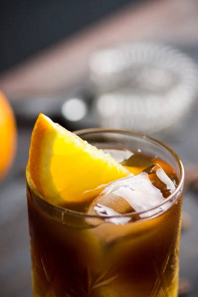 Orange and coffee cocktail on the wooden background