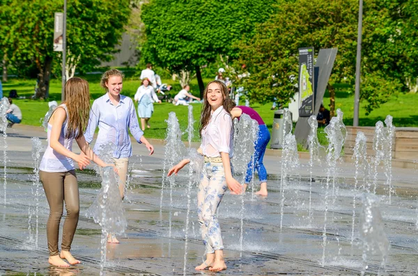 Two girls in fountain.