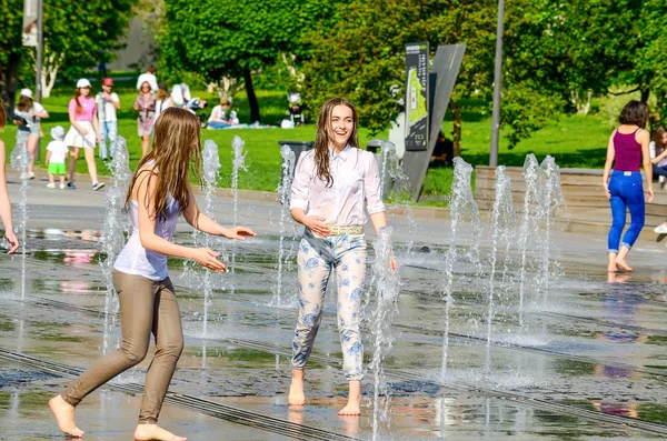 Two girls in fountain.